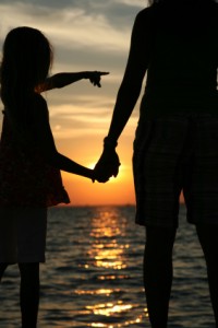 child and parent at beach